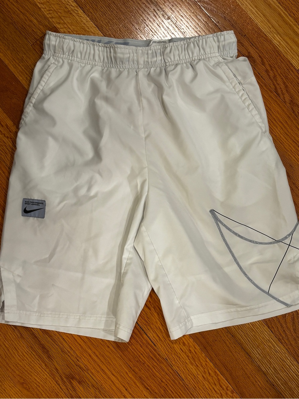 Nike Men's White Athletic Shorts with Gray Swoosh Detail